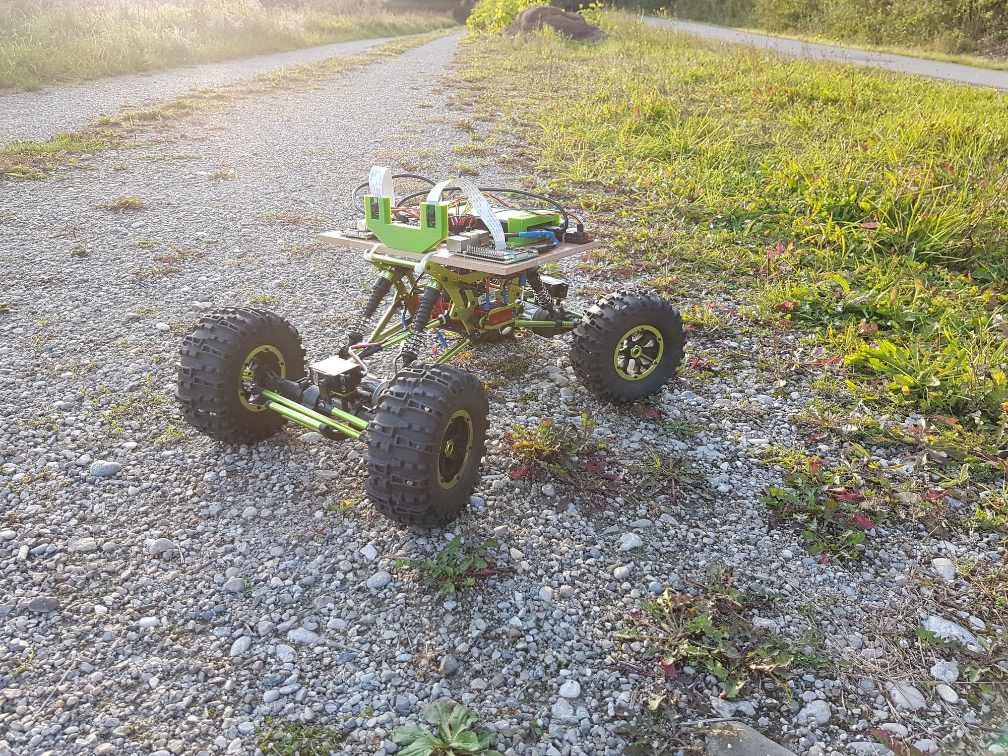 Autonomous car on a gravel path at golden hour