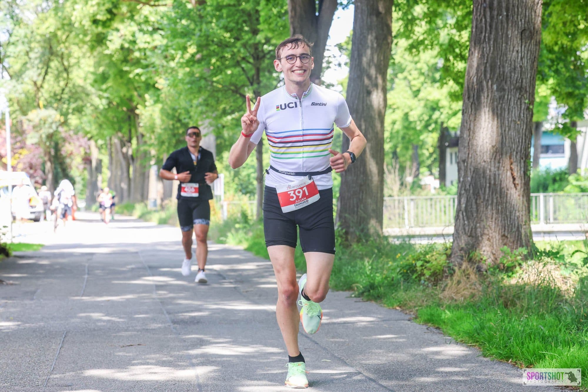 Julian running, peace sign, UCI rainbow jersey