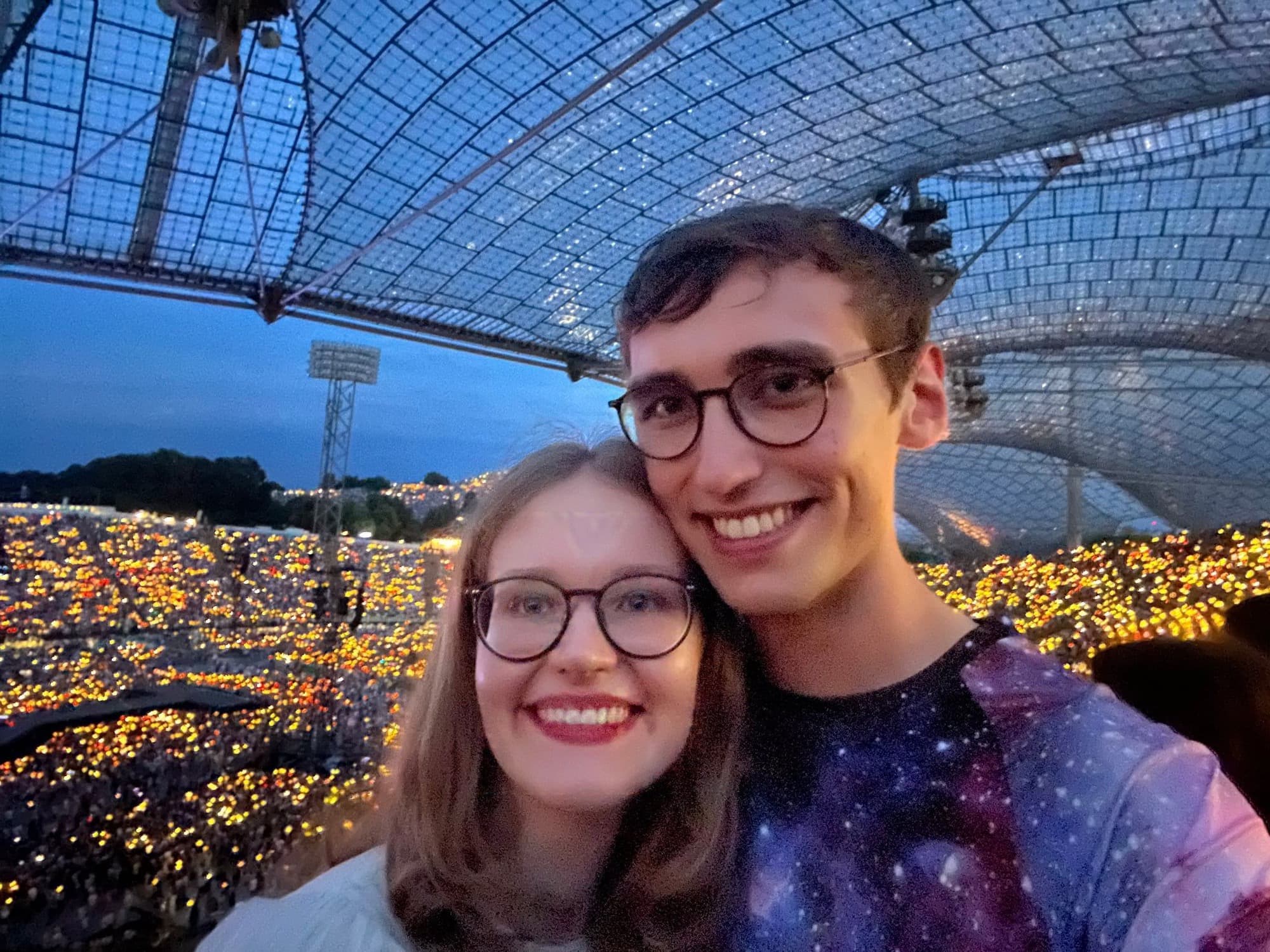 Rooftop at night, city lights behind