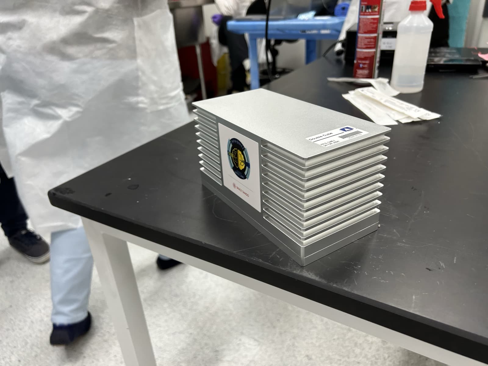 Sealed ADDONISS experiment cube with mission patch, flight ready