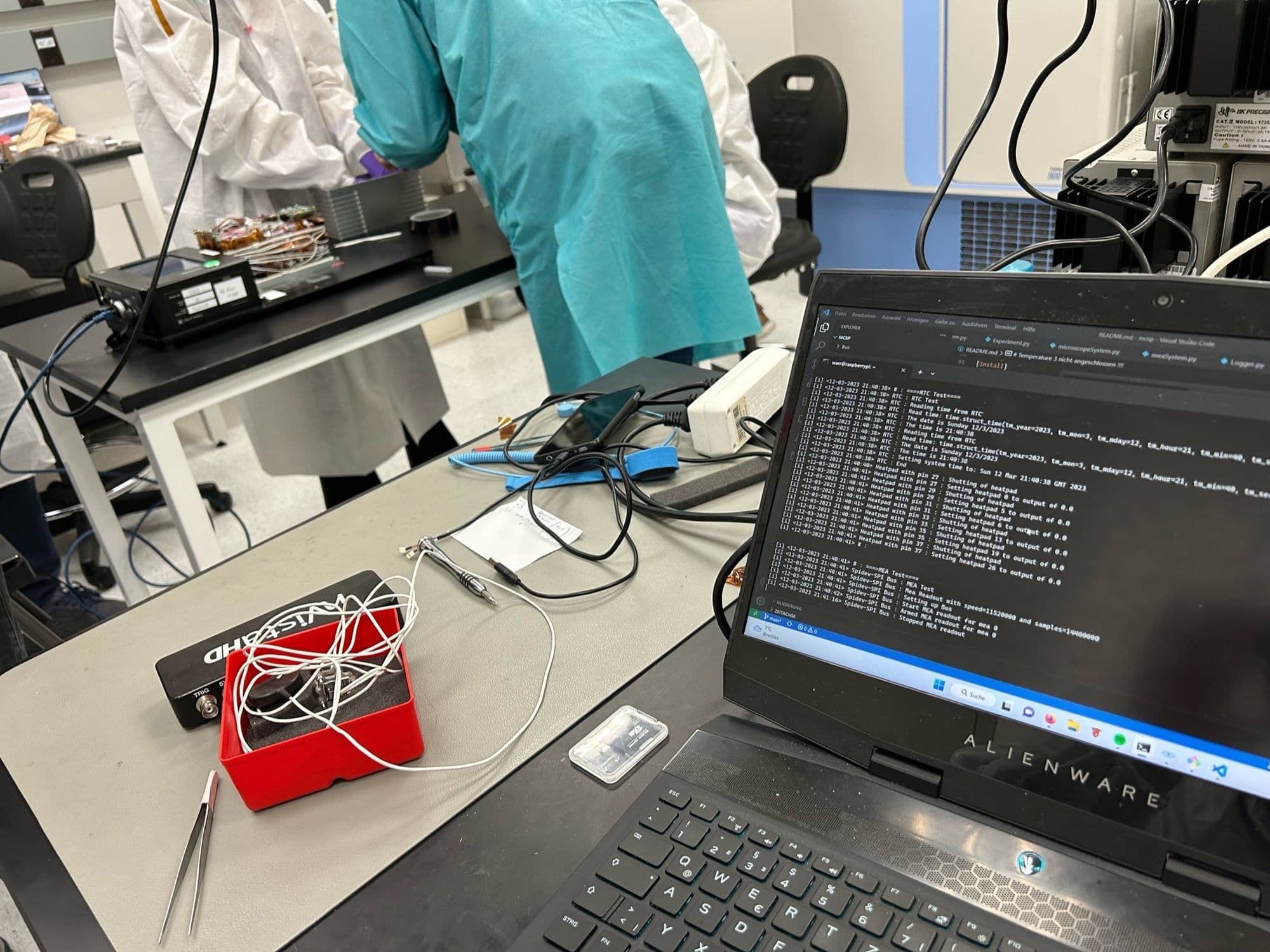 Laptop running experiment software next to Raspberry Pi in cleanroom